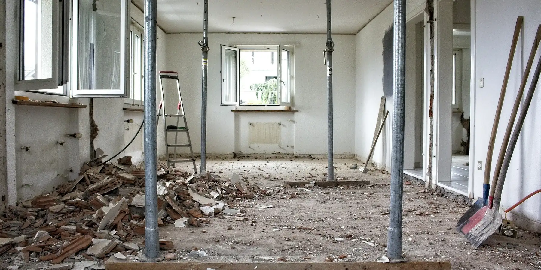 Interior stripped back to bare walls and shoring during a remodeling project